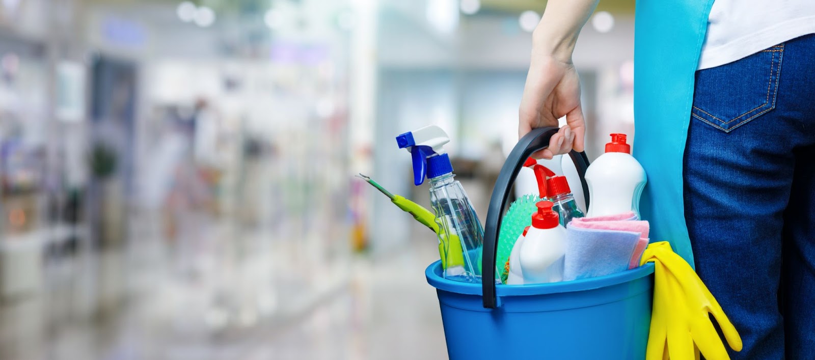 A person holding a bucket filled with cleaning supplies, ready to tackle a professional cleaning checklist for a service.