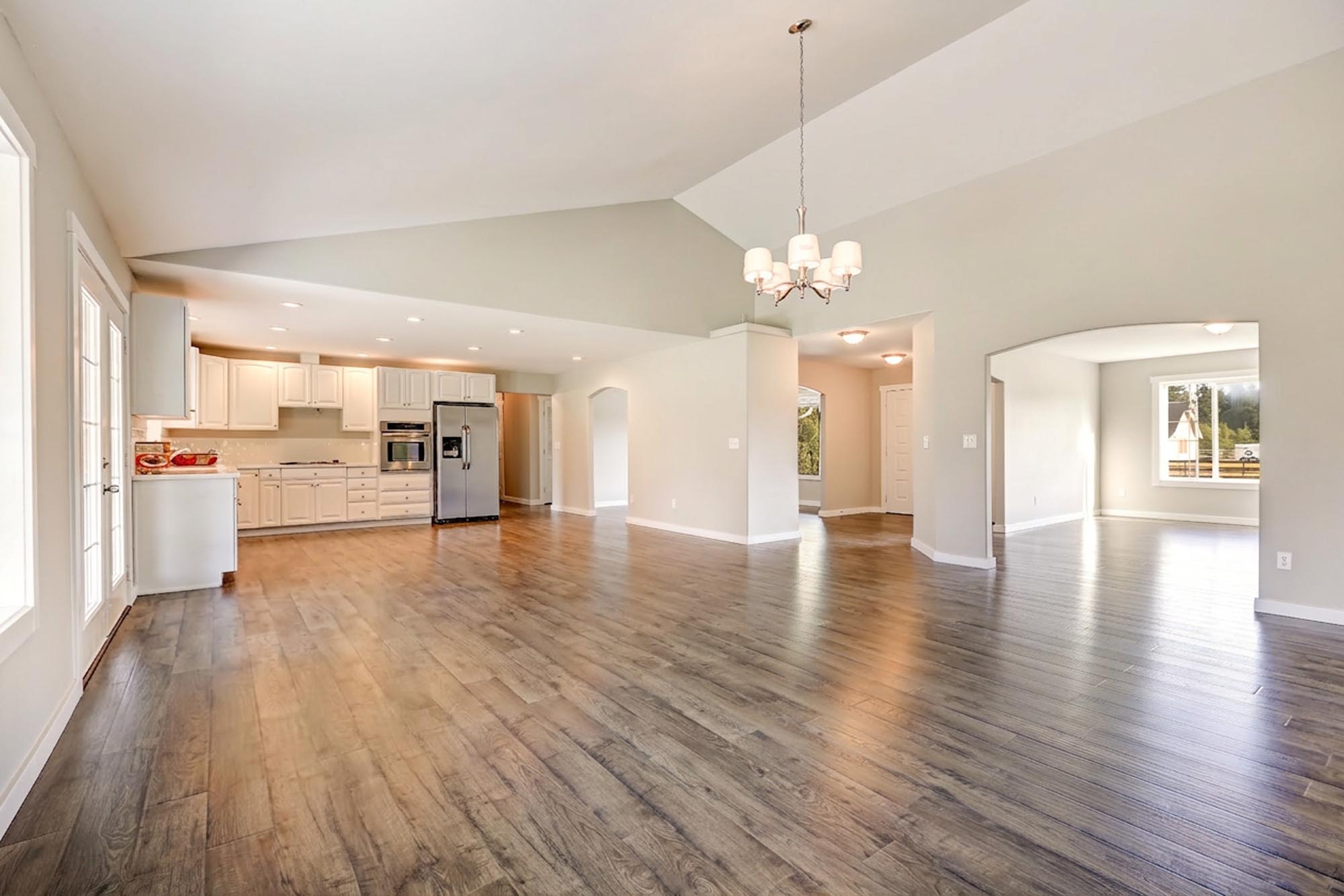 A spacious kitchen and dining area featuring hardwood floors, showcasing a bright and inviting atmosphere.